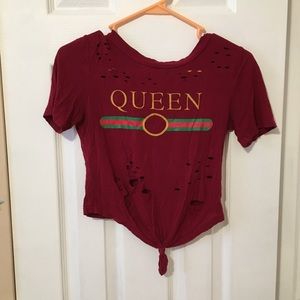queen crop top with a distressed design